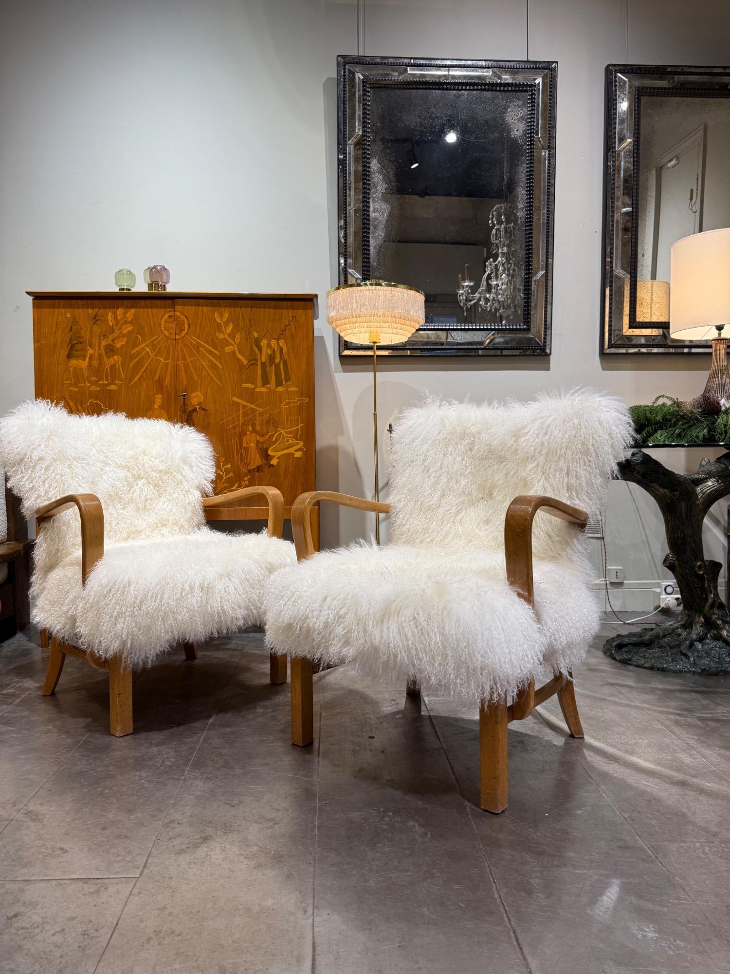 Pair of F Hansen armchairs circa 1940 with sheepskin cushions 