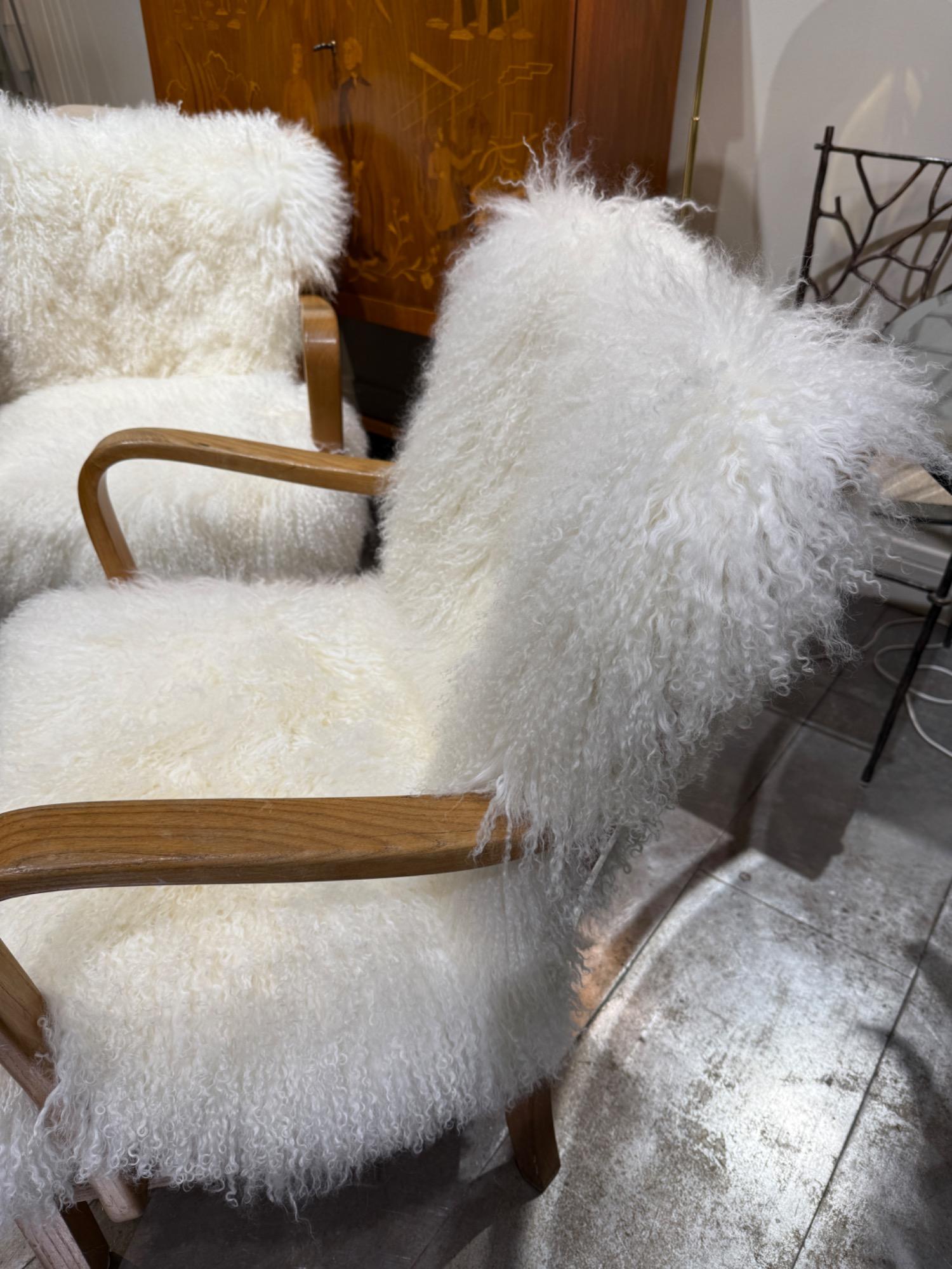 Pair of F Hansen armchairs circa 1940 with sheepskin cushions 