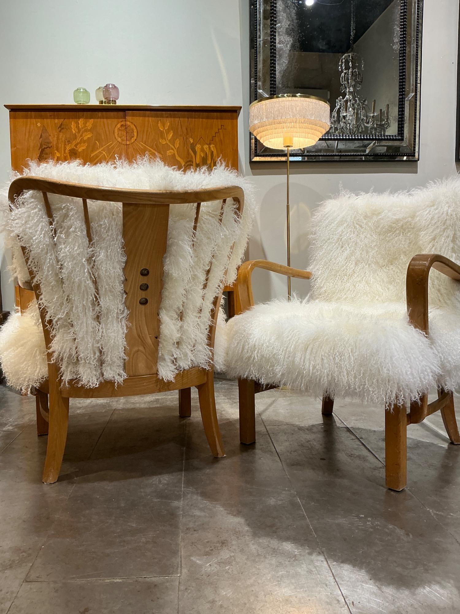 Pair of F Hansen armchairs circa 1940 with sheepskin cushions 